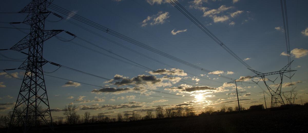 Powerlines running through a blue sunny sky